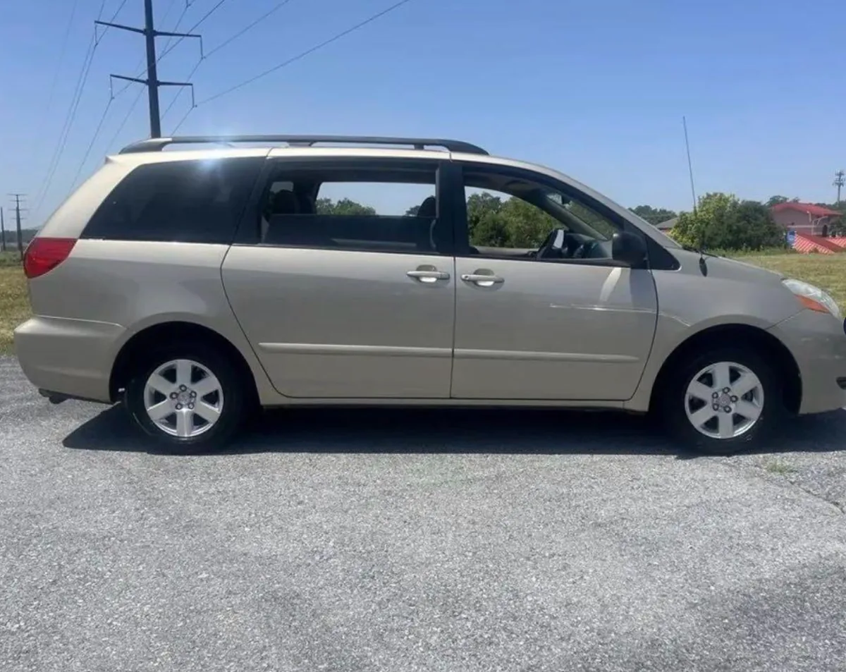 Toyota Sienna minivan in gold, photographed from the driver's side